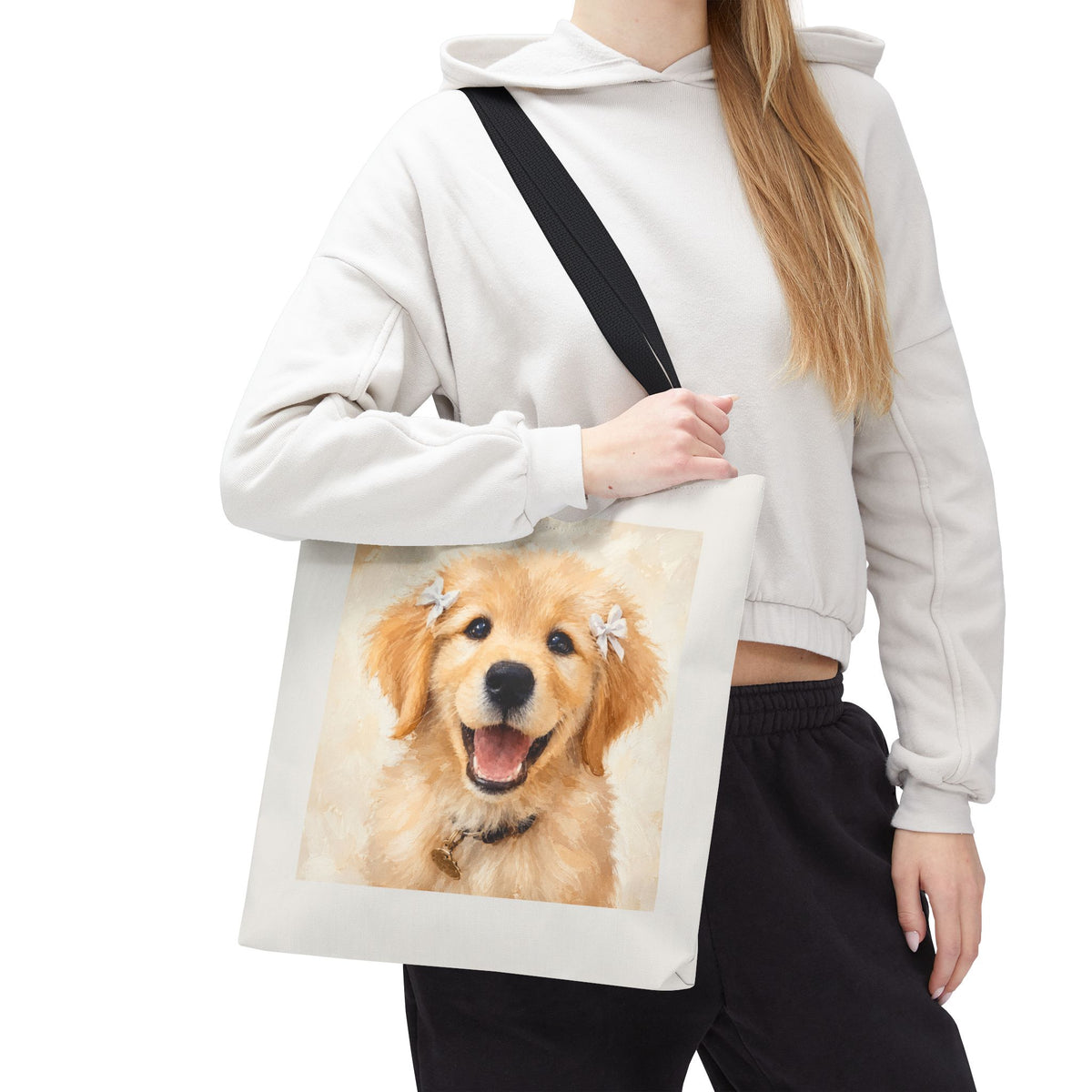 Tote bag printed with a Golden Retriever puppy wearing small white hair ribbons in warm watercolor
