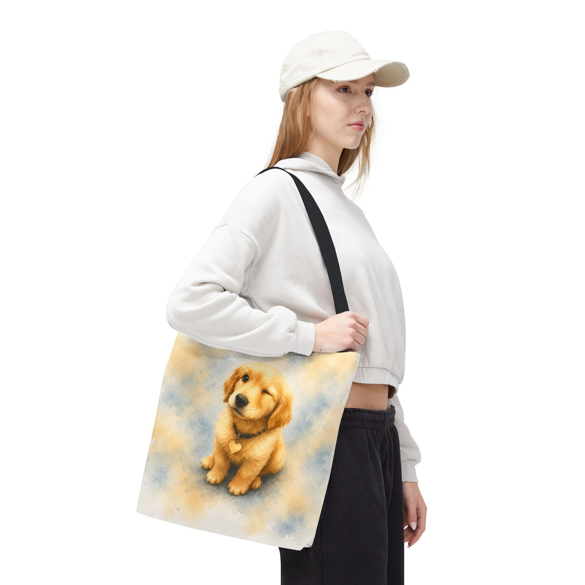Tote bag printed with a winking Golden Retriever puppy in soft yellow and dusty blue watercolor