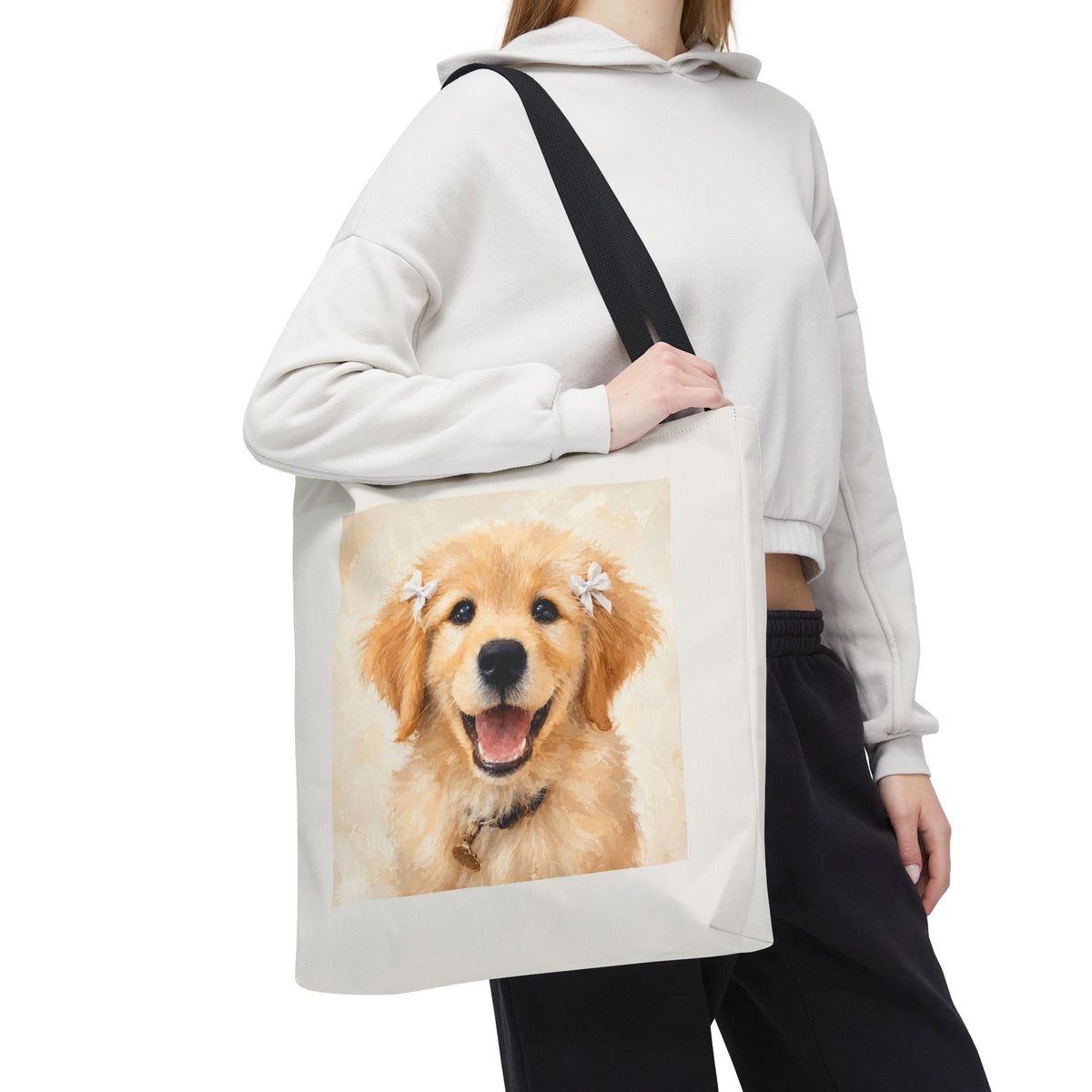 Tote bag printed with a Golden Retriever puppy wearing small white hair ribbons in warm watercolor