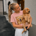 Peachy boxy t-shirt printed with a Golden Retriever puppy wearing hair ribbons and grinning