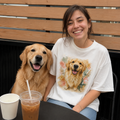 Natural t-shirt printed with a happy Golden Retriever framed by blush and sage watercolor florals