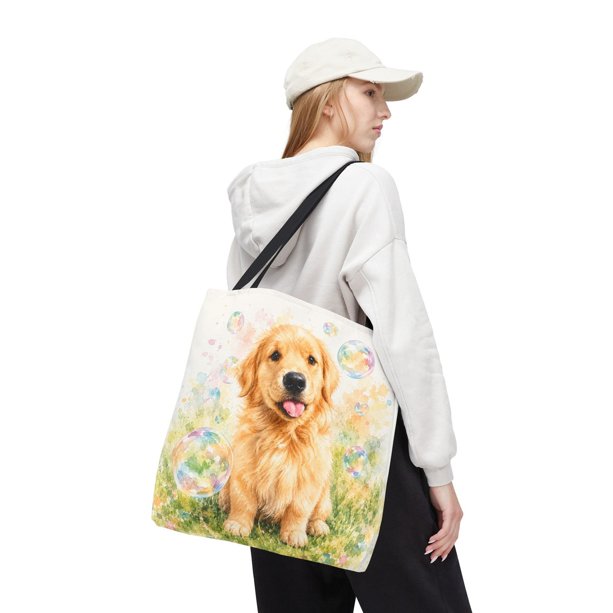 Tote bag printed with a Golden Retriever puppy in a meadow surrounded by pastel floating bubbles
