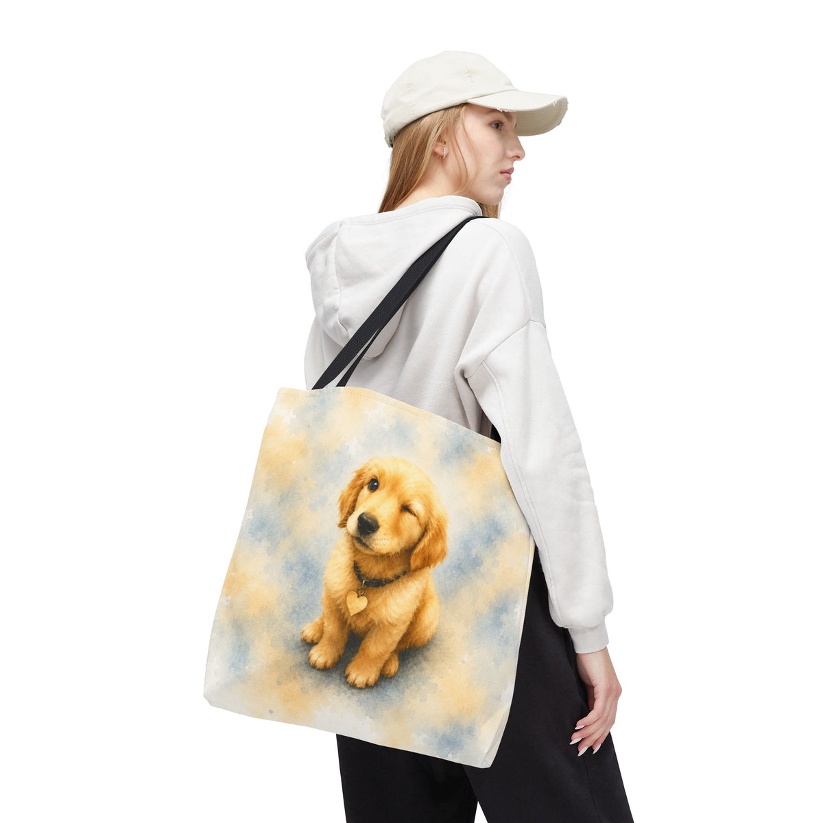 Tote bag printed with a winking Golden Retriever puppy in soft yellow and dusty blue watercolor