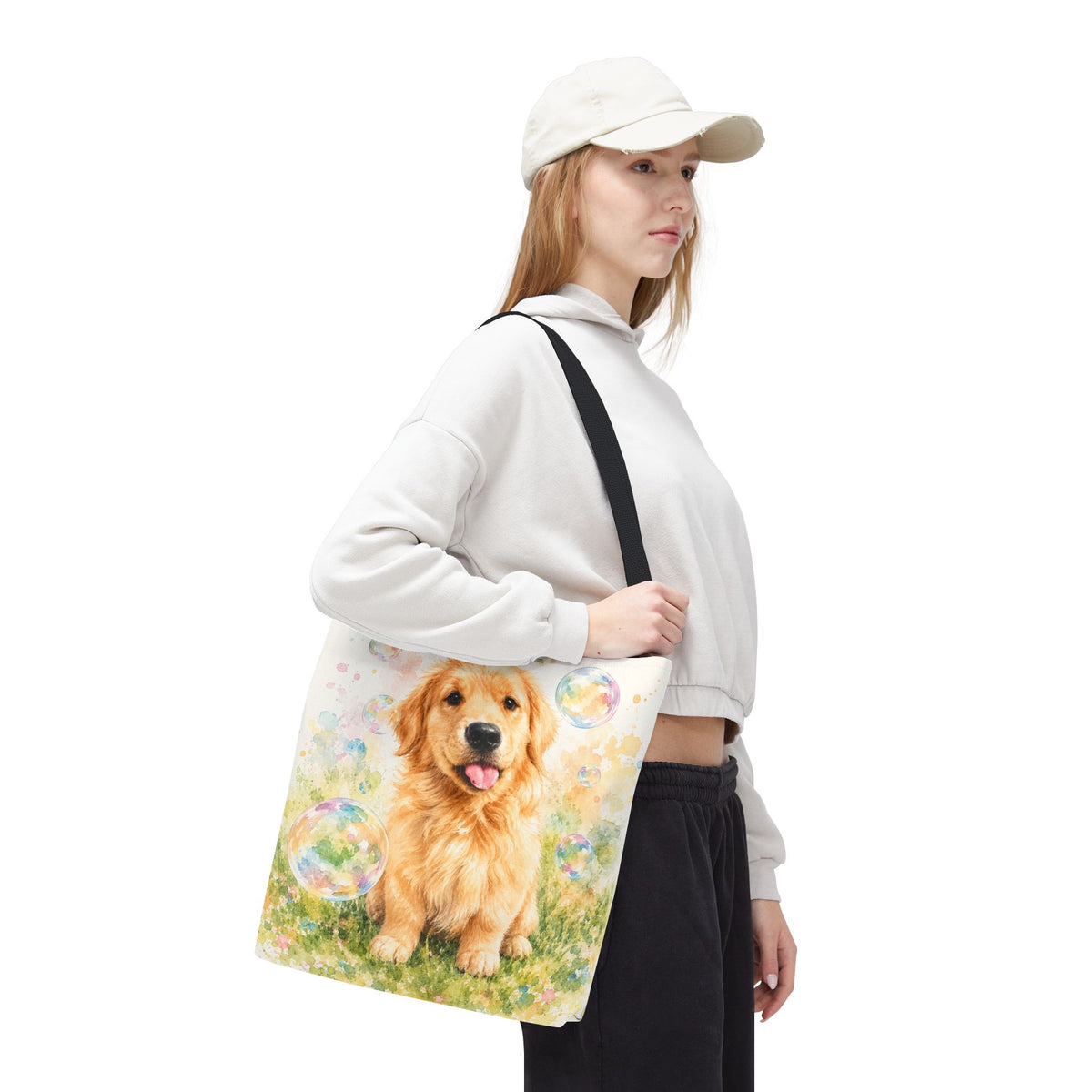 Tote bag printed with a Golden Retriever puppy in a meadow surrounded by pastel floating bubbles