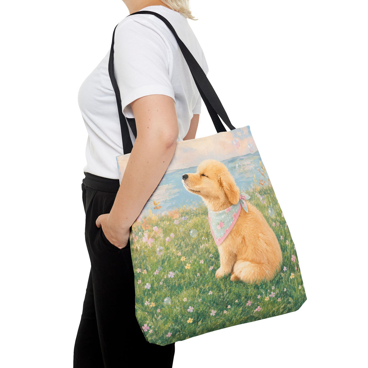 Tote bag printed with a Golden Retriever puppy in a wildflower meadow wearing a pastel bandana