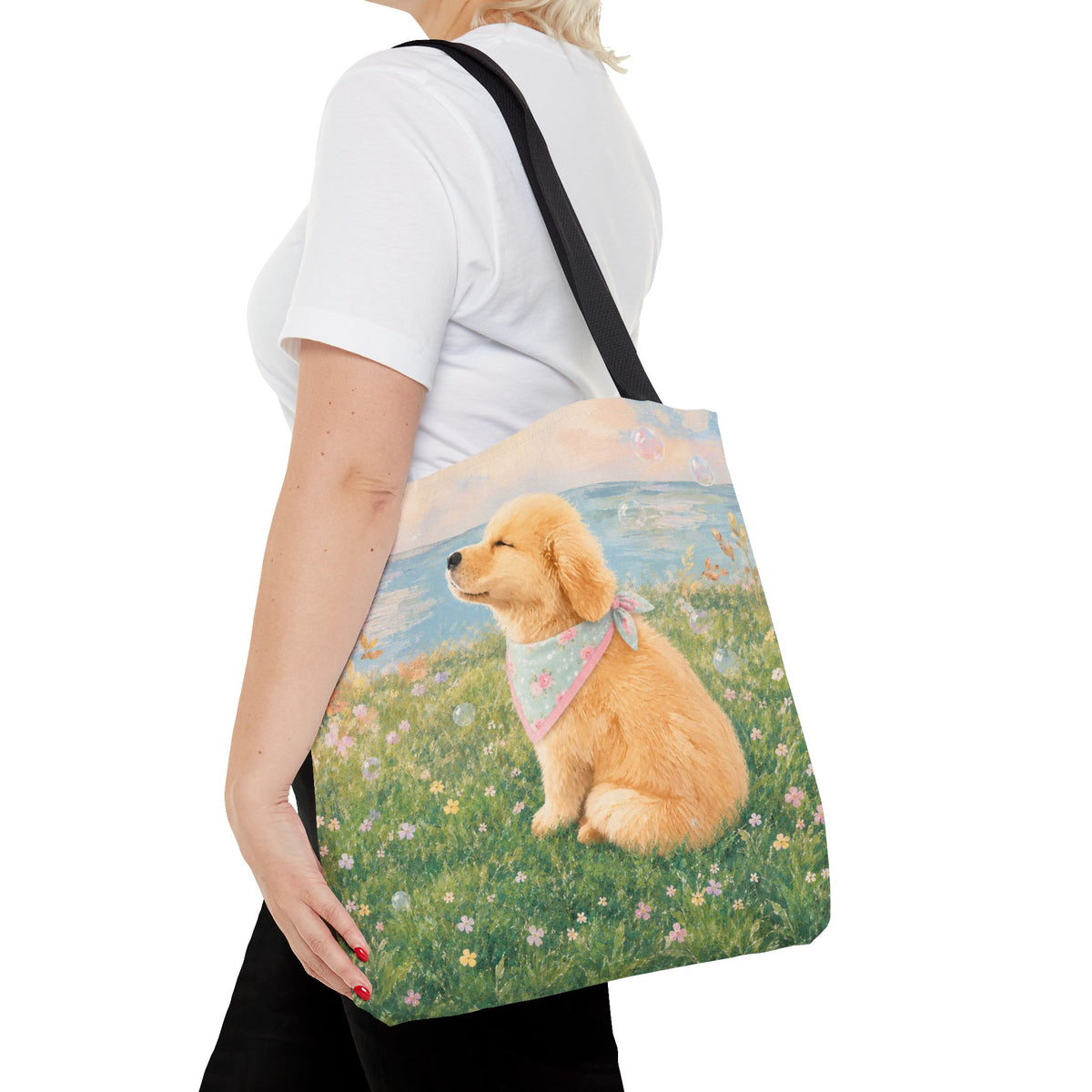 Tote bag printed with a Golden Retriever puppy in a wildflower meadow wearing a pastel bandana